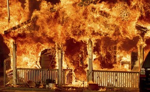 A house is seen completely engulfed in flames.