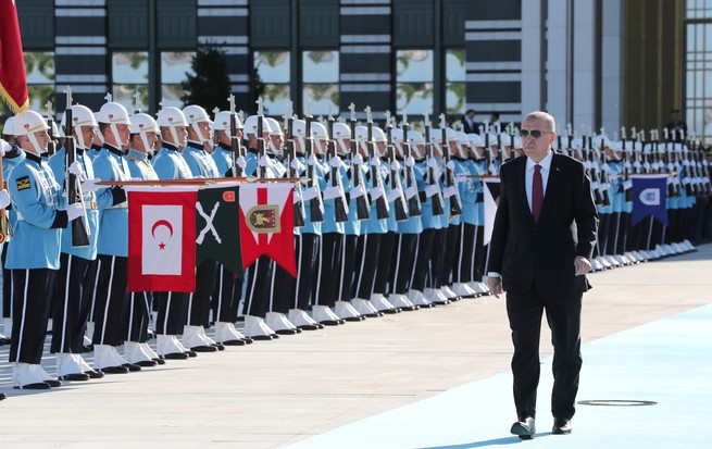 Turkish President Recep Tayyip Erdogan walks past a welcoming ceremony at the presidential palace in Ankara.