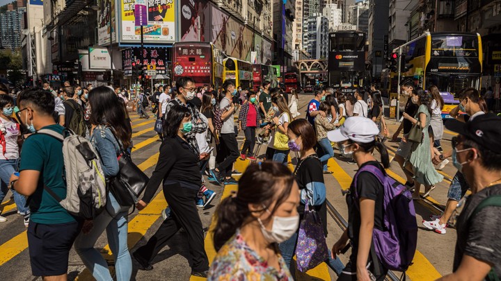 People wear masks at a crowded intersection in Hong Kong.