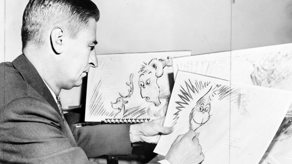 Theodor Seuss Geisel, American writer, poet, and cartoonist, at work on a drawing of a grinch.