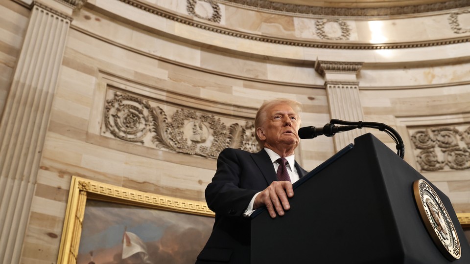 Donald Trump stands at a podium to speak