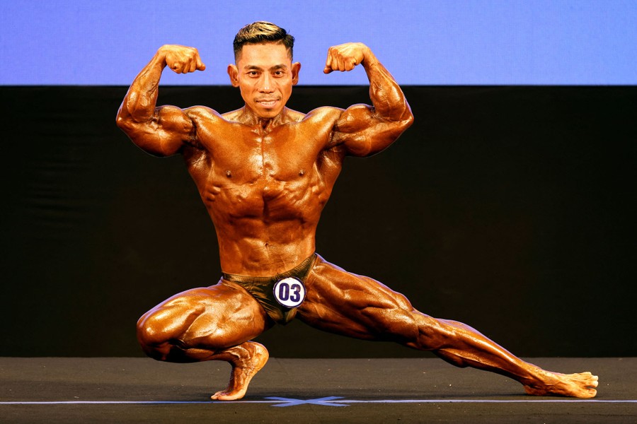 A bodybuilder poses during a competition.