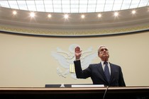 Robert Mueller lifts his right hand up while swearing in to testify in front of the House Judiciary Committee.