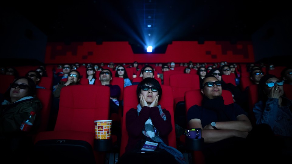 An audience watches a film in a theater in China