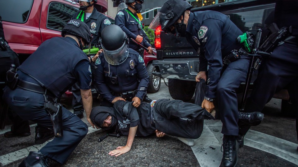Police arrest a protester at a demonstration for Black Lives Matter in Los Angeles on May 29, 2020.