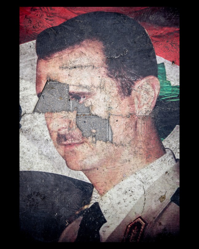 A defaced poster of Bashar al-Assad