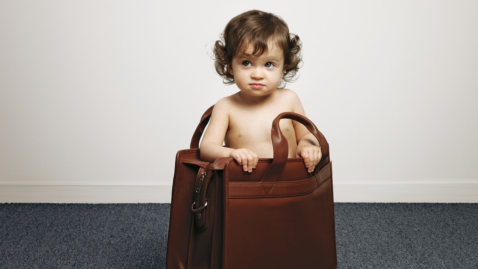 A toddler stands inside a briefcase