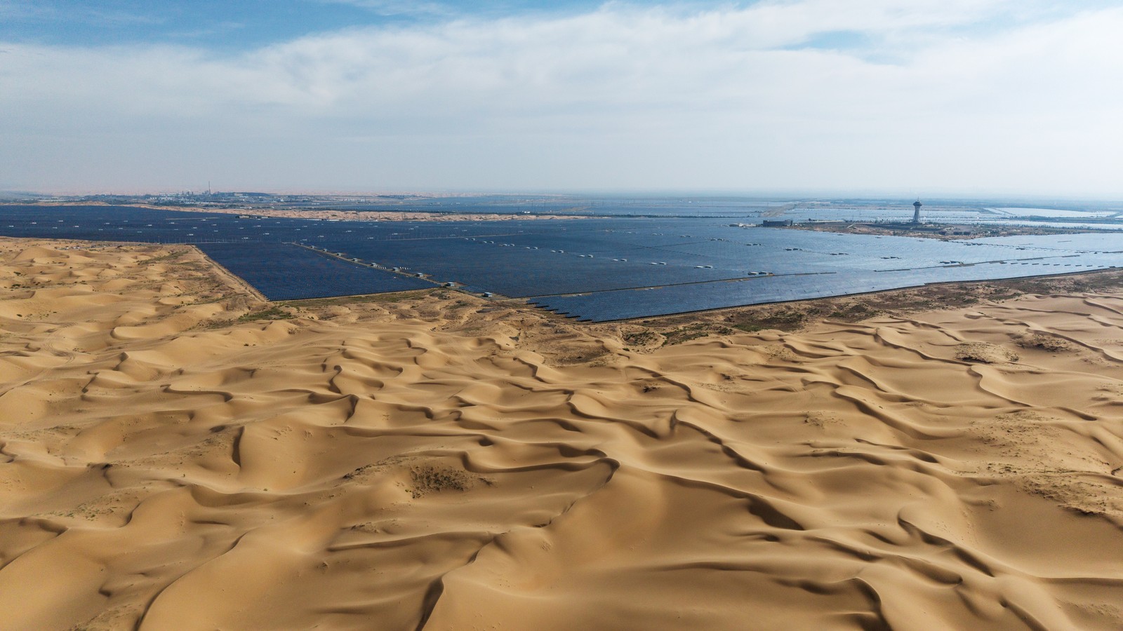 Solar panels stretch to the horizon in a Chinese desert facility.