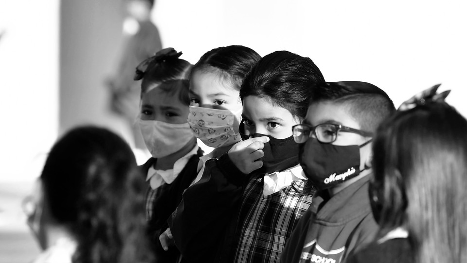 A row of children in face masks