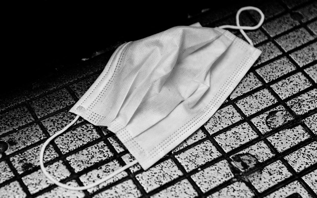 A surgical mask on the ground