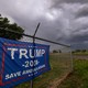 A storm brews in the sky above a Trump 2024 flag