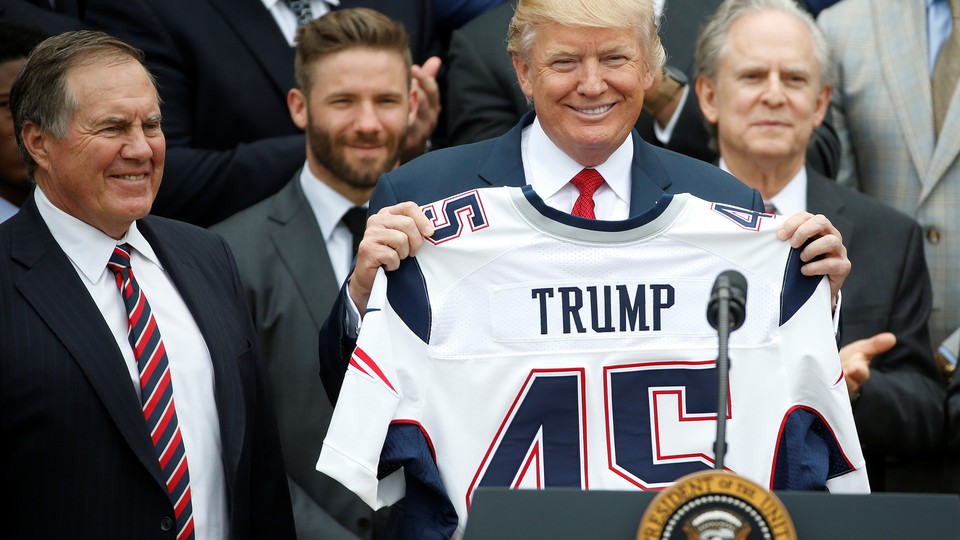 President Trump holds up a New England Patriots jersey during an event honoring the Super Bowl champions at the White House on April 19, 2017