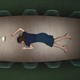 Still from "Severance" of a woman lying facedown on a conference table