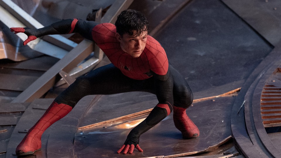 Tom Holland posing on a building as Spider-Man in 'Spider-Man: No Way Home'