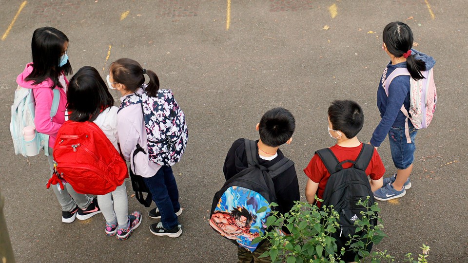 children in masks gathered at a New York elementary school