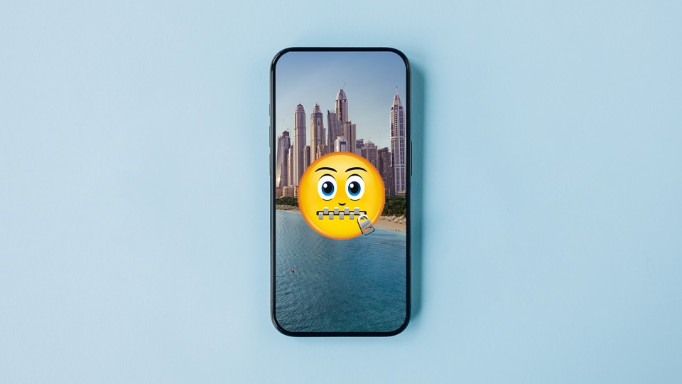 A zipped-lips emoji is superimposed over a picture of the Dubai skyline.