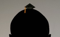 Big head wearing tiny graduation cap