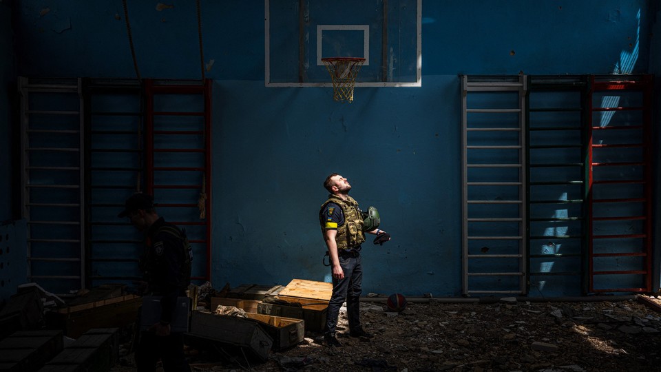 Ukrainian police officer standing in an empty gym