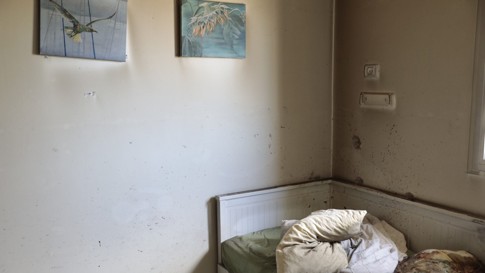 A bed and two pictures in an abandoned room