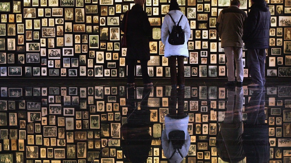 Visitors at the Birkenau Museum view the faces of the men, women and children at Auschwitz II-Birkenau.
