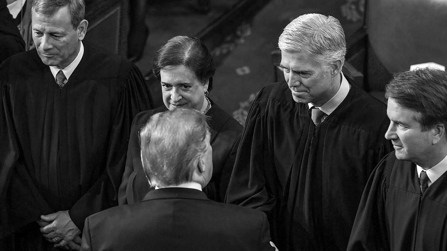 black-and-white photo of Supreme Court justices John Roberts, Elena Kagan, Neil Gorsuch, and Brett Kavanaugh standing in a line, Gorsuch shaking Donald Trump's hand