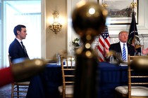 Jared Kushner sits at a table with Donald Trump.