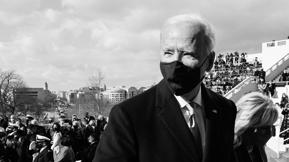 A black-and-white photo shows President Joe Biden and First Lady Jill Biden leaving the inauguration dais.