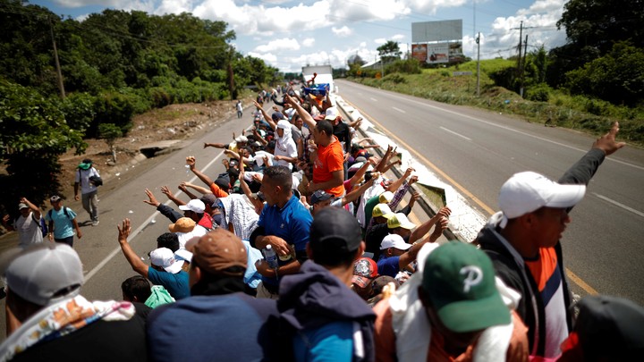 Central American migrants hitchhike on a truck along the highway as they continue their journey in Tapachula, Mexico, on October 22, 2018.