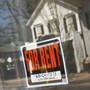 A "for rent" sign hangs in the window of a home.