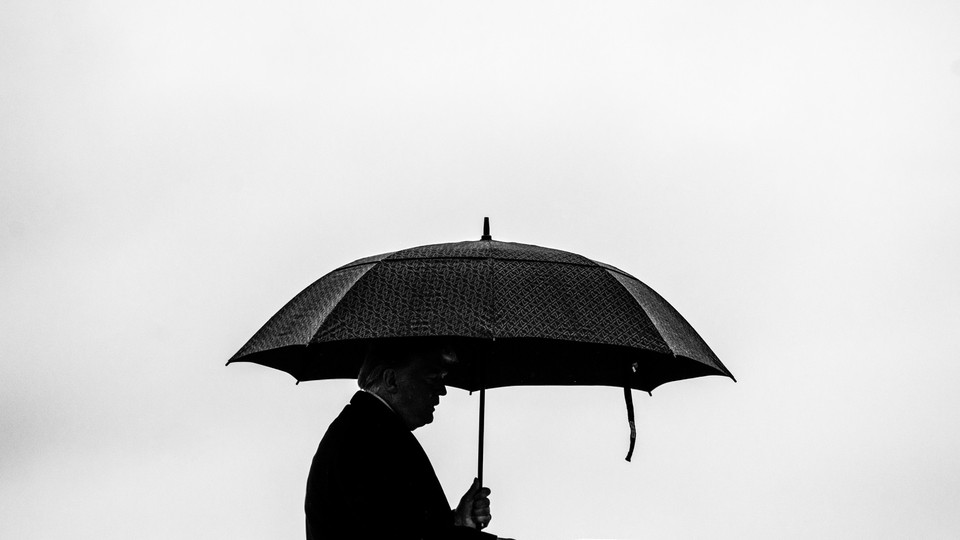 Donald Trump under an umbrella
