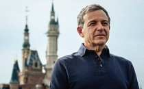 Bob Iger standing in front of a Disney castle