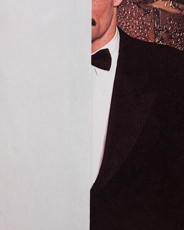 The left half is plain grey, the right half is a man in a tuxedo with a mustache, his face obscured