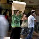 Woman holding "Free Hugs" sign