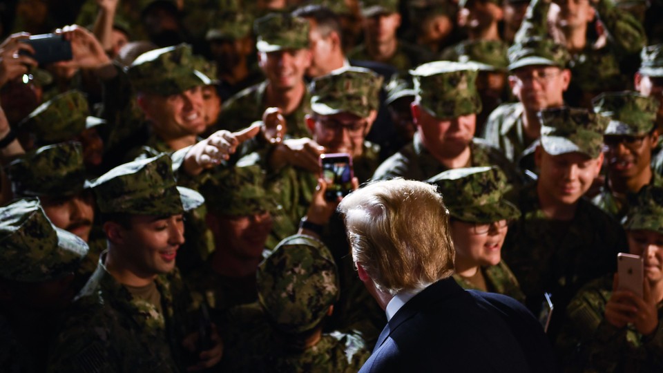 Donald Trump greets a group of marines.