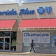 A person walks by a health-care insurance office in Hialeah, Florida.