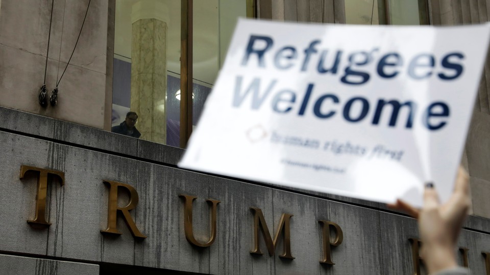 Protesters gather outside the Trump Building to take action against America’s refugee ban.
