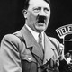A black and white photo of Hitler delivering a speech.