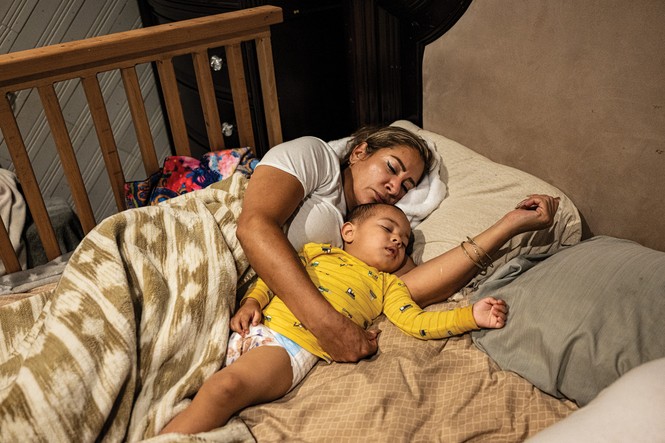 photo of woman and very young boy in diaper asleep in bed