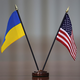 A photo of a small Ukrainian flag besides a small American one
