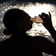 a person downs a hydrating drink