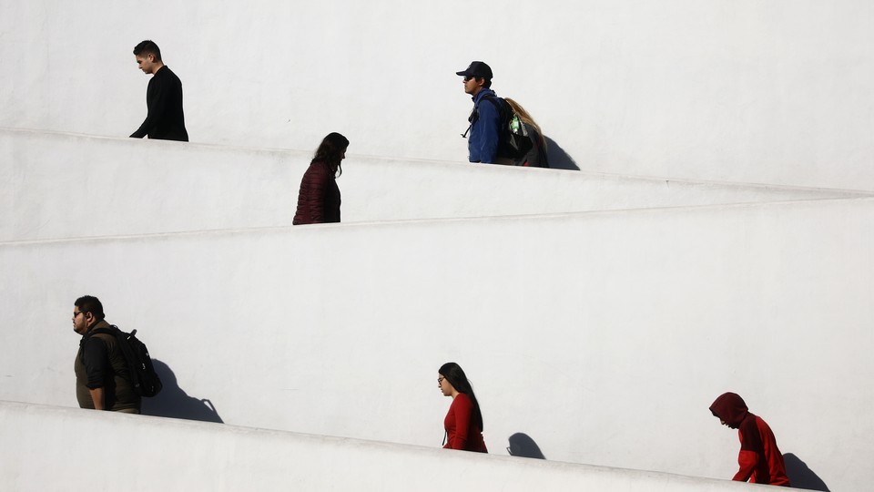 People going up an inclined zigzag pathway