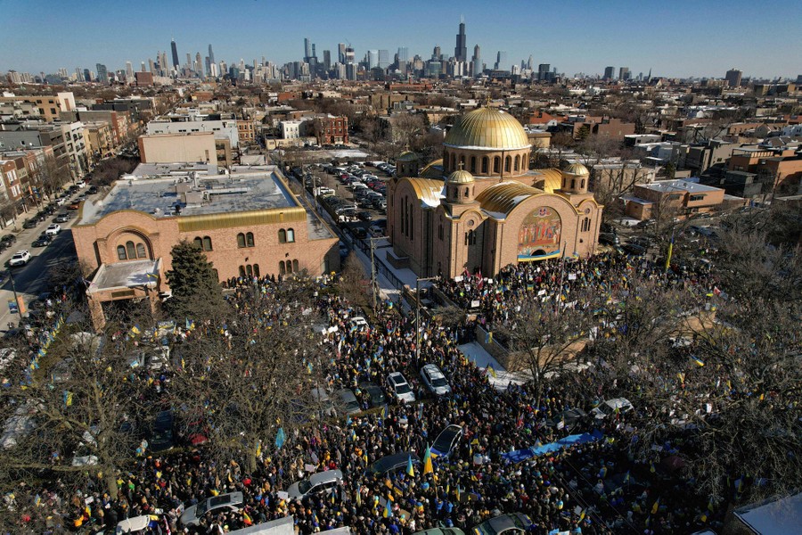 An aerial view of a large crowd of protesters gathered in front of a church in Chicago