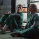 Eddie Redmayne and Jessica Chastain sit on the floor of a hospital in "The Good Nurse"