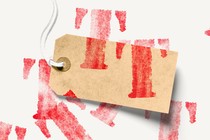 A blank price tag stamped haphazardly with a capital "T"