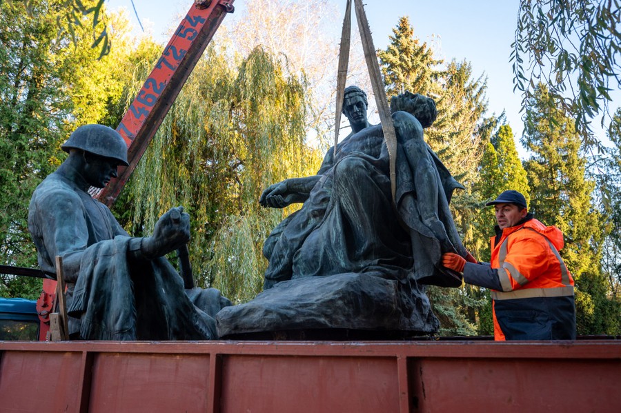 Statues are loaded onto a truck.