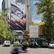 On a street in Tehran, anti-Israel banners cover the side of a high rise building.