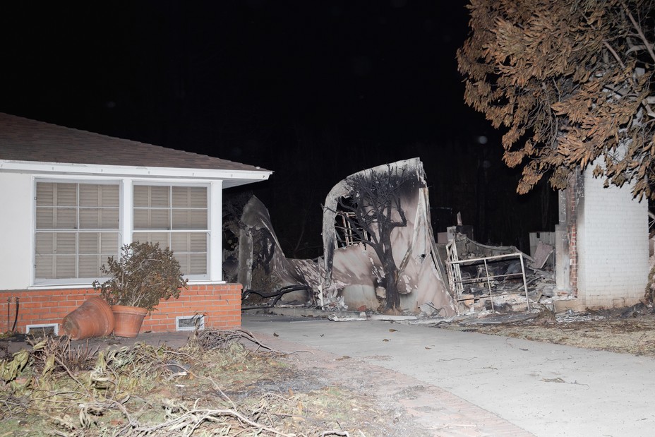 A burned down home and a burned tree