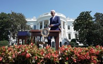 Joe Biden walks up to a small "bill signing" desk in the White House Rose Garden in the photo taken yesterday.