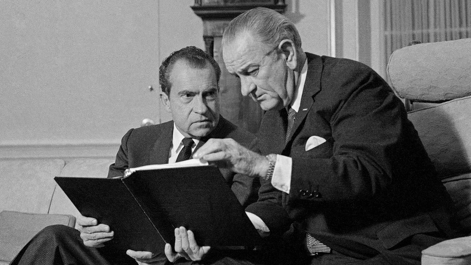 Lyndon B. Johnson and Richard Nixon speak in the Oval Office.