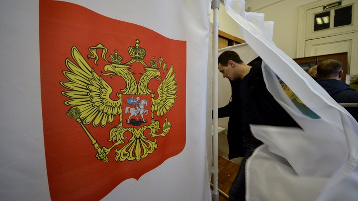 A man enters a polling booth in Russia's 2018 presidential elections.